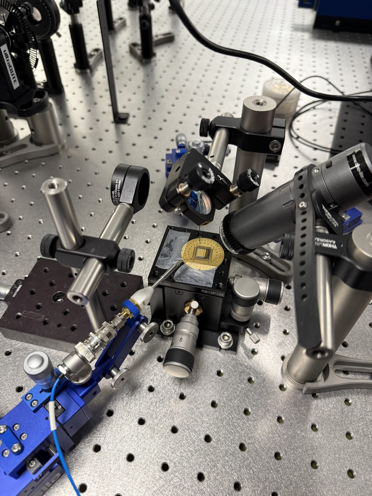 A picosecond-pulse generation chip on its PCB being characterised on the optical table